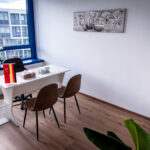 Modern office with desk and plant, window view