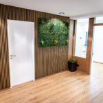 Modern office space with wood paneling and plant walls